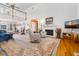 Spacious living room with a fireplace, wood floors, soaring ceilings, and a loft at 8551 Pope Landing Rd, Edisto Island, SC 29438