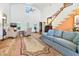 Cozy living room with a fireplace, soaring ceilings, and a staircase to a loft at 8551 Pope Landing Rd, Edisto Island, SC 29438