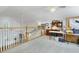 Spacious and bright loft with white railing overlooking the floor below and a built-in desk with shelving at 8551 Pope Landing Rd, Edisto Island, SC 29438