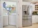 Pantry closet next to stainless refrigerator including washer and dryer and offering ample storage space at 8551 Pope Landing Rd, Edisto Island, SC 29438