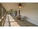 Relaxing screened porch with ceiling fans, wicker chairs, and a hammock; perfect for outdoor living at 8551 Pope Landing Rd, Edisto Island, SC 29438