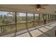 Spacious screened porch with wood floors, ceiling fans, and views of the marsh at 8551 Pope Landing Rd, Edisto Island, SC 29438
