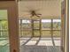 The screened porch features natural light, a ceiling fan, and a view of a marsh at 8551 Pope Landing Rd, Edisto Island, SC 29438