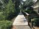 Private walkway through lush greenery leading towards waterfront at 8551 Pope Landing Rd, Edisto Island, SC 29438