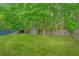 Large backyard with a storage shed and wooden fence surrounded by beautiful mature trees at 9156 Fieldstone Trce, Summerville, SC 29485