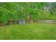 Large backyard with a storage shed and wooden fence surrounded by beautiful mature trees at 9156 Fieldstone Trce, Summerville, SC 29485