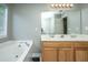 Bathroom features soaking tub, double vanity, and large mirror at 9156 Fieldstone Trce, Summerville, SC 29485