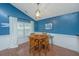 Dining room featuring blue walls, wood floors, a vaulted ceiling, and a window at 9156 Fieldstone Trce, Summerville, SC 29485