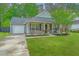 Charming single-story home with a well-manicured lawn, flowering bushes and an attached garage at 9156 Fieldstone Trce, Summerville, SC 29485