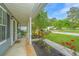 Charming front porch with red roses, a rocking chair, and a welcoming 'welcome' mat at 9156 Fieldstone Trce, Summerville, SC 29485