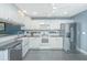 Kitchen boasts white cabinets, granite countertops, and stainless steel refrigerator at 9156 Fieldstone Trce, Summerville, SC 29485