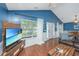Well-lit living room with tv set, hardwood floors, and a view to the front entrance at 9156 Fieldstone Trce, Summerville, SC 29485