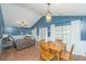 Open concept living space with a dining table and a leather couch with entertainment area at 9156 Fieldstone Trce, Summerville, SC 29485