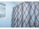 Close-up of a stylish shower curtain with a modern geometric pattern and a window at 9156 Fieldstone Trce, Summerville, SC 29485