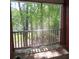 View of a peaceful screen enclosed balcony overlooking lush, mature trees at 9163 Parlor Dr, Ladson, SC 29456