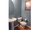 Compact half-bathroom with a pedestal sink, toilet, and neutral wall color at 9163 Parlor Dr, Ladson, SC 29456