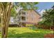 Expansive backyard with lush green grass, mature trees, and a patio area perfect for entertaining at 9316 Sweetbay Ct, Ladson, SC 29456