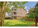 Lush backyard with mature trees, a patio area, and ample green space for outdoor activities at 9316 Sweetbay Ct, Ladson, SC 29456