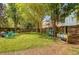 Expansive backyard with mature trees, lush green grass, and a privacy fence for outdoor enjoyment at 9316 Sweetbay Ct, Ladson, SC 29456