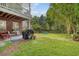 Patio area with outdoor furniture, a lush lawn, and a privacy fence for secluded relaxation at 9316 Sweetbay Ct, Ladson, SC 29456