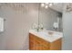 Stylish bathroom featuring a vanity with drawers, a decorative mirror, and modern lighting at 9316 Sweetbay Ct, Ladson, SC 29456