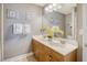Bathroom with double sinks, wooden vanity, and ample lighting, creating a functional and stylish space at 9316 Sweetbay Ct, Ladson, SC 29456
