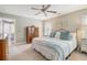 Cozy bedroom featuring a ceiling fan, neutral walls, carpeted floors, and stylish furnishings at 9316 Sweetbay Ct, Ladson, SC 29456