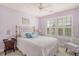 Serene bedroom with plush carpeting, brass bed frame, and abundant natural light streaming through shuttered windows at 9316 Sweetbay Ct, Ladson, SC 29456