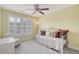 Inviting bedroom with bright natural light, cozy daybed, and neutral decor, offering a peaceful retreat at 9316 Sweetbay Ct, Ladson, SC 29456