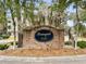 Elegant brick community sign, surrounded by mature trees and lush landscaping at 9316 Sweetbay Ct, Ladson, SC 29456