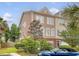 Stylish townhome featuring a two-car garage, mature trees, and well-maintained landscaping at 9316 Sweetbay Ct, Ladson, SC 29456