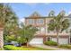Charming townhome exterior with well-manicured landscaping, garage, and palm trees at 9316 Sweetbay Ct, Ladson, SC 29456
