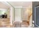 Inviting foyer with hardwood floors, neutral paint, and view into the living room at 9316 Sweetbay Ct, Ladson, SC 29456