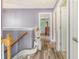 Hallway featuring hardwood floors and a stair lift, providing accessibility and convenience at 9316 Sweetbay Ct, Ladson, SC 29456