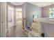 Upstairs hallway featuring a stairlift, leading to a bedroom with ample natural light at 9316 Sweetbay Ct, Ladson, SC 29456