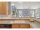 Bright kitchen area with wood cabinets, stainless steel appliances, undermount sink and view into living room at 9316 Sweetbay Ct, Ladson, SC 29456