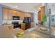 Modern kitchen features wood cabinets, stainless steel appliances, ample counter space, seamlessly blending with the living area at 9316 Sweetbay Ct, Ladson, SC 29456