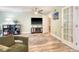 Comfortable living room featuring light green walls, an entertainment center, and stylish decor at 9316 Sweetbay Ct, Ladson, SC 29456