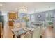 Open-concept living area with a modern glass table, plenty of seating, and lots of light, perfect for relaxation at 9316 Sweetbay Ct, Ladson, SC 29456