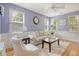 Comfortable living room with natural light, ceiling fan, plush seating, and stylish decor at 9316 Sweetbay Ct, Ladson, SC 29456
