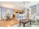 Open concept living and dining area with hardwood floors, modern lighting, and bar seating at kitchen counter at 9316 Sweetbay Ct, Ladson, SC 29456