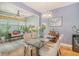 Inviting dining area featuring a chandelier, glass table, seating for four, and seamlessly connected to the living area at 9316 Sweetbay Ct, Ladson, SC 29456