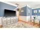 Spacious living room displays a large television, hardwood floors, and neutral colored decor at 9316 Sweetbay Ct, Ladson, SC 29456