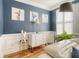 Corner of a living room showcasing a white dresser, stylish decor, and warm hardwood floors at 9316 Sweetbay Ct, Ladson, SC 29456