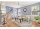 Inviting living room showcases blue walls, hardwood floors, ceiling fan and natural light at 9316 Sweetbay Ct, Ladson, SC 29456