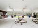 Relaxing outdoor patio with ceiling fans, picnic tables, and pool view for gatherings and leisure at 9316 Sweetbay Ct, Ladson, SC 29456