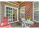 Cozy patio space featuring brick exterior, seating and a sliding glass door at 9316 Sweetbay Ct, Ladson, SC 29456