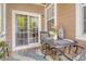 Cozy porch featuring an outdoor table with chairs and decorative elements, perfect for relaxation at 9316 Sweetbay Ct, Ladson, SC 29456