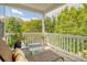 Outdoor porch features lounge chairs and a table with seating surrounded by lush greenery at 9316 Sweetbay Ct, Ladson, SC 29456