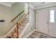 Bright entryway with a staircase featuring wood and white trim at 9316 Sweetbay Ct, Ladson, SC 29456